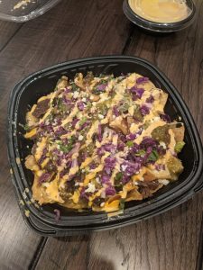 Take out container filled with nachos