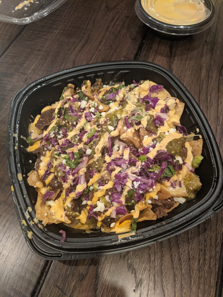 Take out container filled with nachos